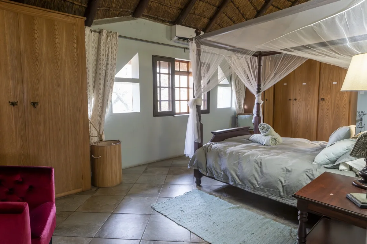 Main bedroom with four poster king size bed